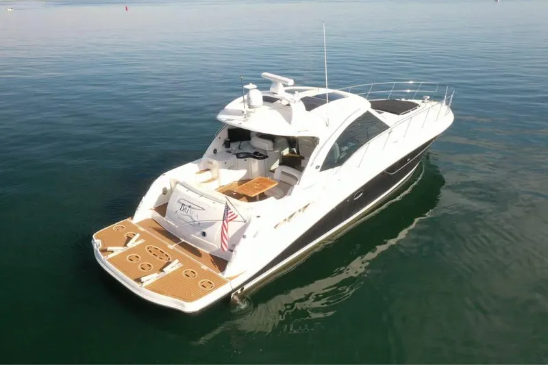 Slide: The Image of 2012 Sea Ray 500 Sundancer yacht on calm water, rear view. - 2