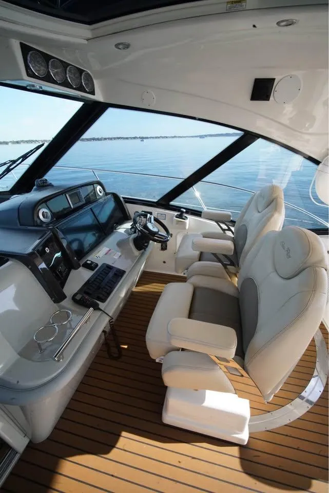 Slide: The Image of Luxurious 2012 Sea Ray 500 Sundancer helm with modern controls and plush seating. - 7