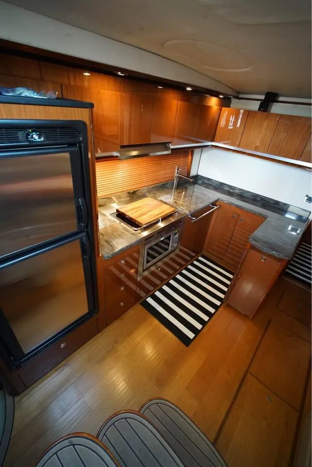 Slide: The Image of Luxurious kitchen interior of 2012 Sea Ray 500 Sundancer yacht with modern amenities. - 8