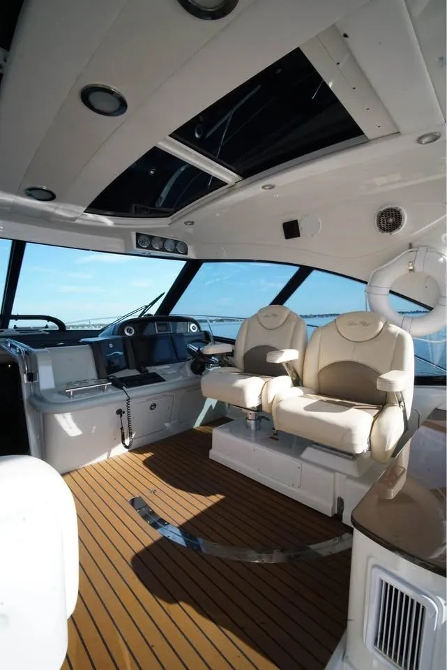 Slide: The Image of Luxurious interior of 2012 Sea Ray 500 Sundancer yacht with plush seating and modern controls. - 9