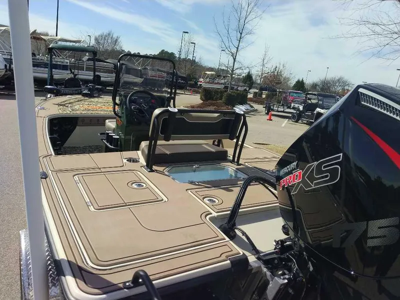 Slide: The Image of 2025 Mako 18 Pro Skiff Backwater Edition boat with powerful engine, parked outdoors. - 4