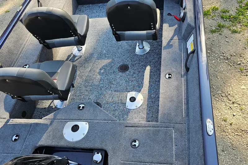 Slide: The Image of 2025 Tracker Pro Guide V-16 SC boat interior with seating and storage compartments. - 2
