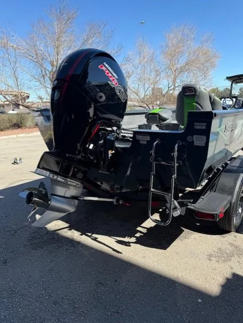 Slide: The Image of 2025 Ranger VS1882SC Angler boat with powerful outboard motor, parked outdoors. - 11