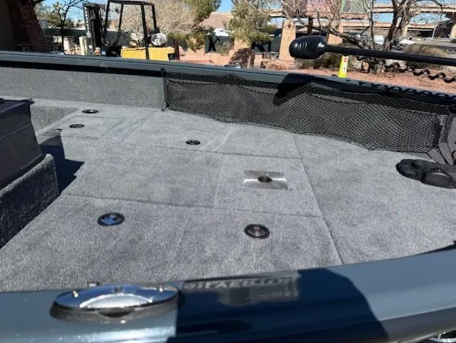 Slide: The Image of 2025 Ranger VS1882SC Angler boat deck with gray carpet and storage compartments. - 12