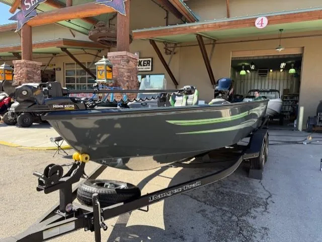 Slide: The Image of 2025 Ranger VS1882SC Angler boat on trailer outside a store. - 2