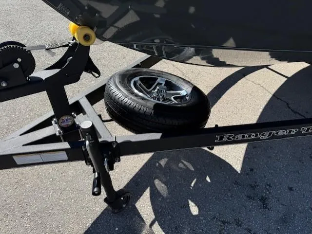 Slide: The Image of Trailer of 2025 Ranger VS1882SC Angler boat with spare tire on asphalt. - 4