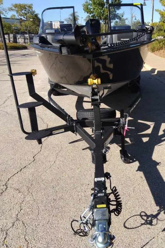 Slide: The Image of 2025 Tracker Targa V-18 WT boat on trailer, parked outdoors. - 4