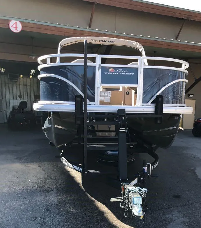 Slide: The Image of 2025 Sun Tracker Fishin' Barge 20 DLX pontoon boat in storage facility. - 3