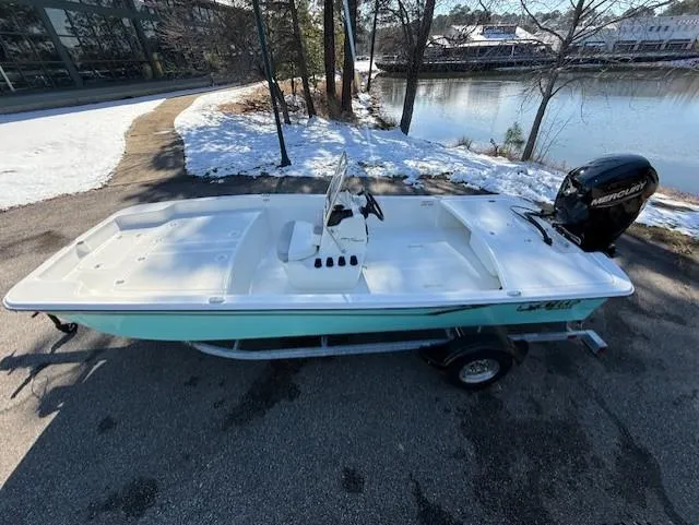 Slide: The Image of 2025 Mako Pro Skiff 17 CC boat on trailer by snowy lakeside. - 44