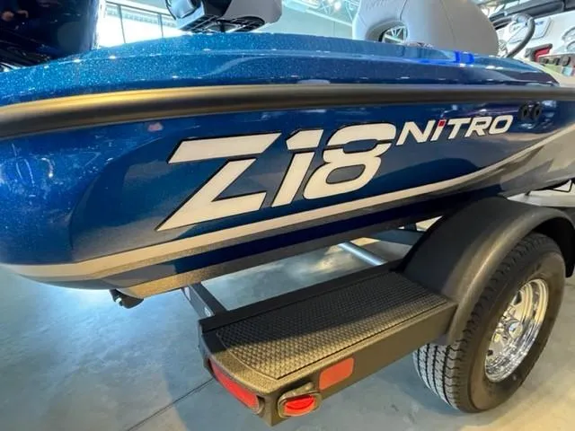 Slide: The Image of 2025 Nitro Z18 boat, blue exterior, on trailer, close-up view. - 2