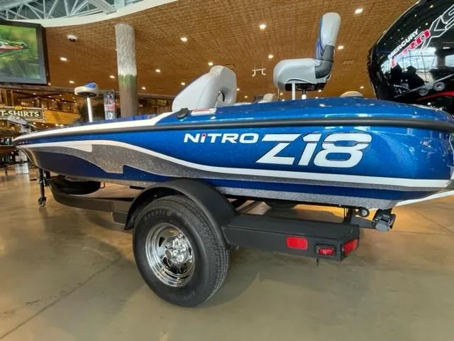 Slide: The Image of 2025 Nitro Z18 boat displayed indoors, featuring sleek blue design and modern seating. - 4