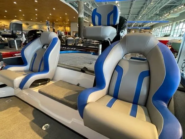 Slide: The Image of 2025 Nitro Z18 boat interior with blue and gray seats in a showroom. - 5