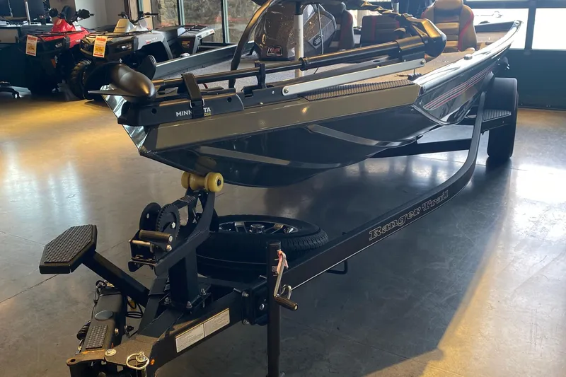 The Image of 2025 Ranger RT178 boat on trailer in showroom, featuring Minn Kota trolling motor. - 0