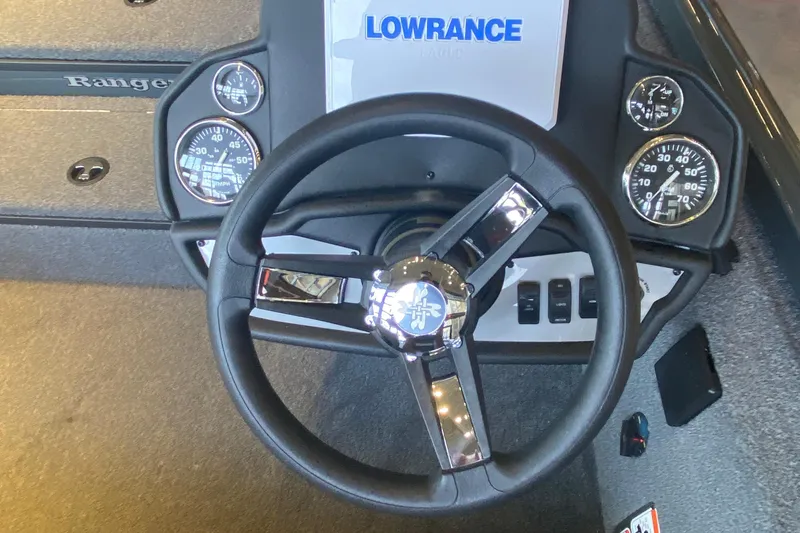Slide: The Image of 2025 Ranger RT178 boat dashboard with steering wheel and gauges, featuring Lowrance electronics. - 2