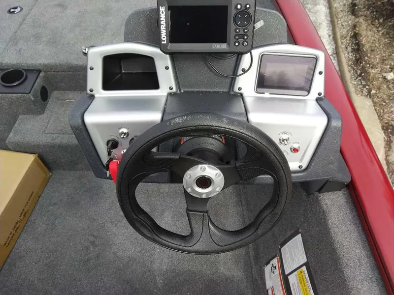Slide: The Image of 2025 Tracker Pro Team 175 boat dashboard with steering wheel and electronic display. - 2