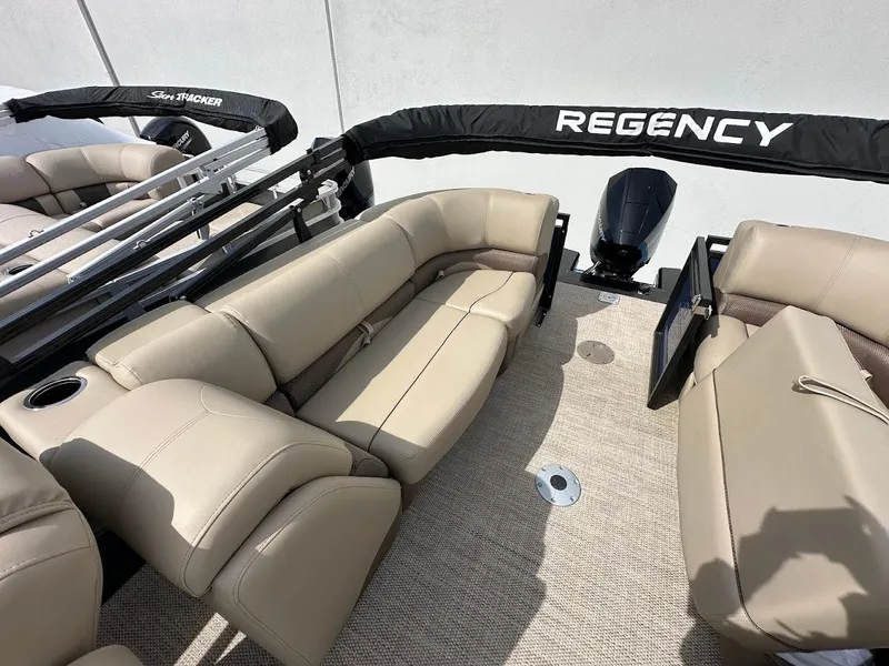 Slide: The Image of 2025 Regency 230 DL3 boat interior with beige seating and sleek design. - 11