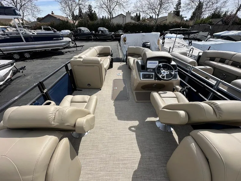 Slide: The Image of 2025 Regency 230 DL3 pontoon boat with spacious seating and modern helm. - 14