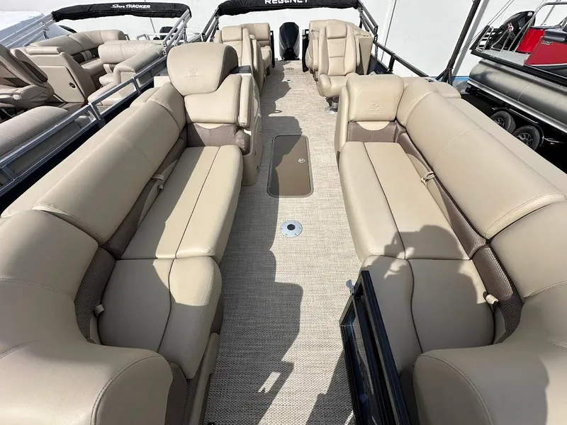 Slide: The Image of 2025 Regency 230 DL3 pontoon boat with spacious beige seating and modern design. - 5