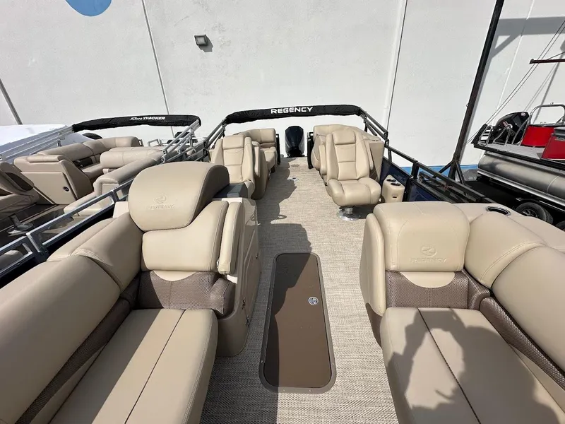 Slide: The Image of 2025 Regency 230 DL3 pontoon boat with luxurious beige seating and spacious deck layout. - 6