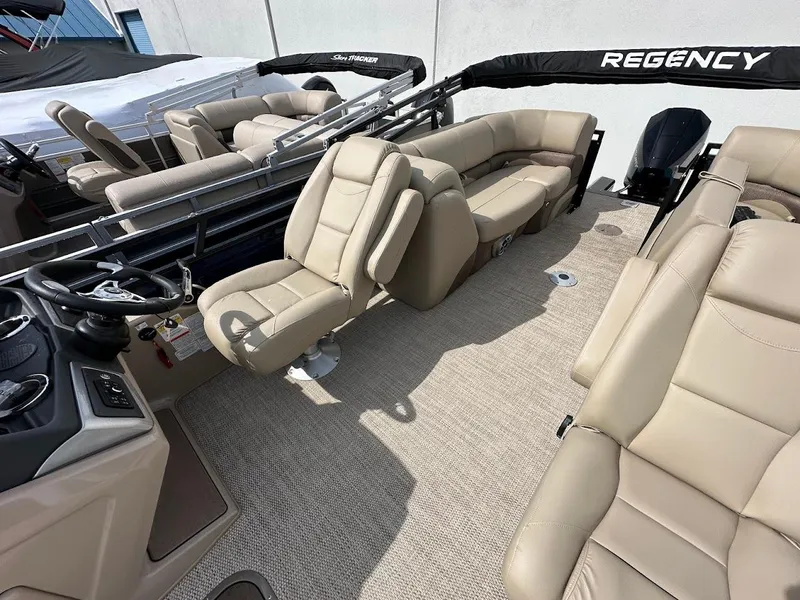 Slide: The Image of 2025 Regency 230 DL3 pontoon boat interior with beige seating and modern design. - 8