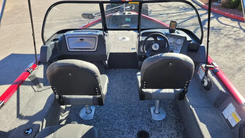 Slide: The Image of 2025 Tracker Pro Guide V-16 WT boat interior with dual seats and dashboard controls. - 7