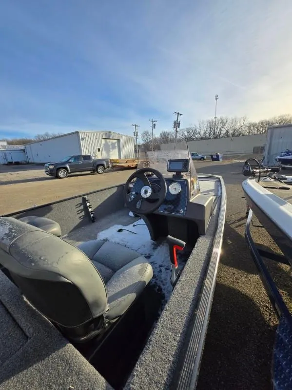 Slide: The Image of 2022 Tracker Bass Tracker Classic XL boat interior with steering wheel and controls. - 10