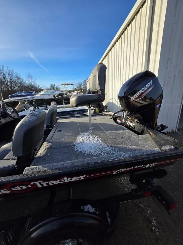 Slide: The Image of 2022 Tracker Bass Tracker Classic XL boat with Mercury engine, parked outdoors. - 14