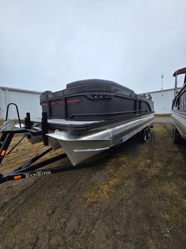 Slide: The Image of 2025 Qwest Splash Pad M-Class pontoon boat on trailer, parked outdoors. - 10
