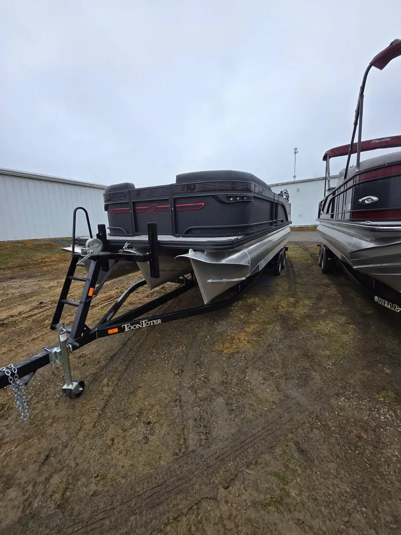 Slide: The Image of 2025 Qwest Splash Pad M-Class boat on trailer, parked outdoors. - 13