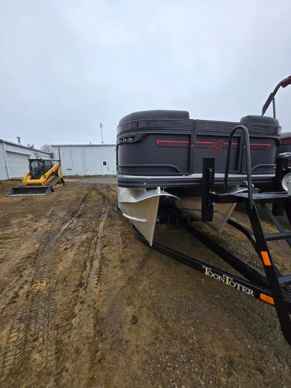 Slide: The Image of 2025 Qwest Splash Pad M-Class pontoon boat on trailer, construction equipment in background. - 9