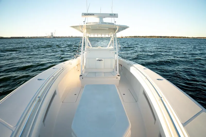 Slide: The Image of 2020 Invincible 36 CC boat on open water, featuring spacious deck and Garmin equipment. - 10
