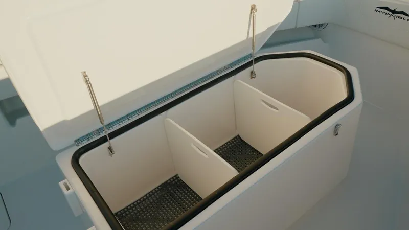 Slide: The Image of Open storage compartment on 2020 Invincible 36 CC boat with dividers. - 12