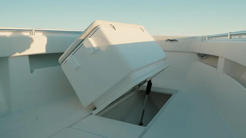 Slide: The Image of 2020 Invincible 36 CC boat with open storage compartment on deck. - 14