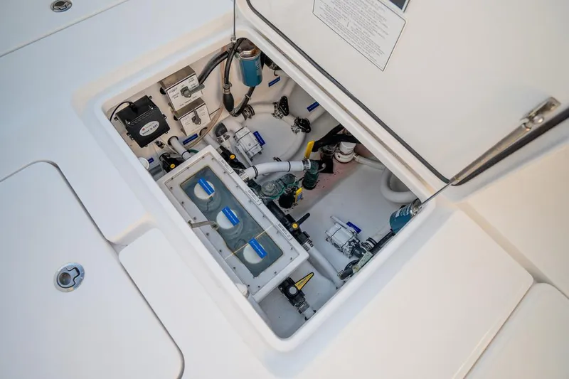 Slide: The Image of 2020 Invincible 36 CC boat compartment with electrical and plumbing components. - 16
