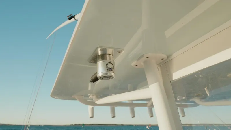 Slide: The Image of 2020 Invincible 36 CC boat detail with mounted equipment under canopy, ocean background. - 17