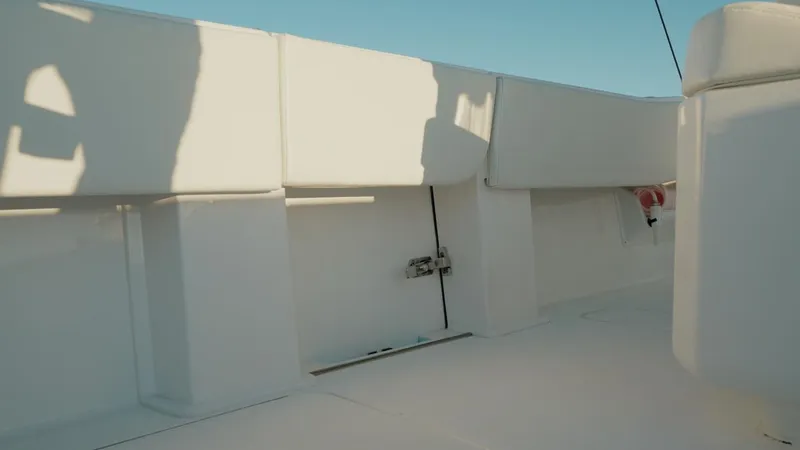 Slide: The Image of 2020 Invincible 36 CC boat interior with white seating and clear sky. - 18