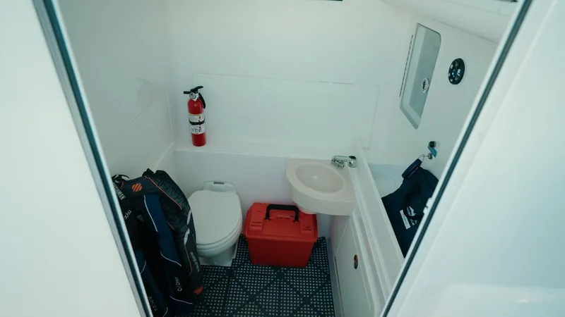 Slide: The Image of Interior of 2020 Invincible 36 CC boat bathroom with toilet, sink, and fire extinguisher. - 20