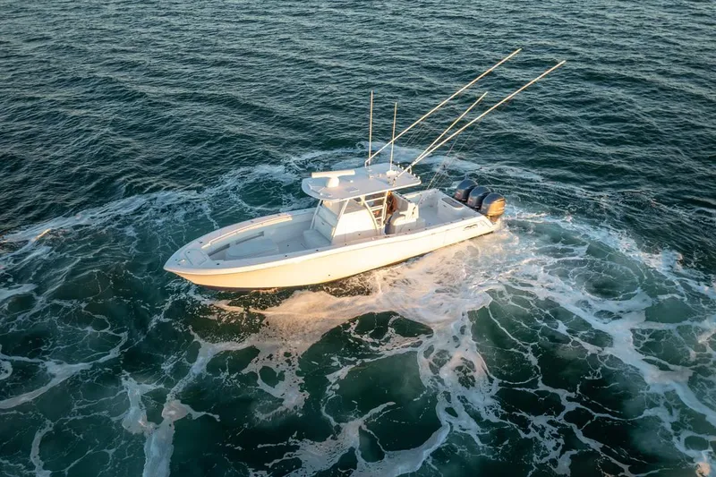 Slide: The Image of 2020 Invincible 36 CC boat navigating ocean waters, aerial view. - 3