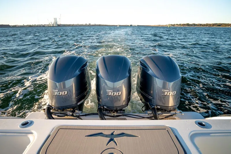 Slide: The Image of 2020 Invincible 36 CC boat with triple Yamaha 300 engines on open water. - 4