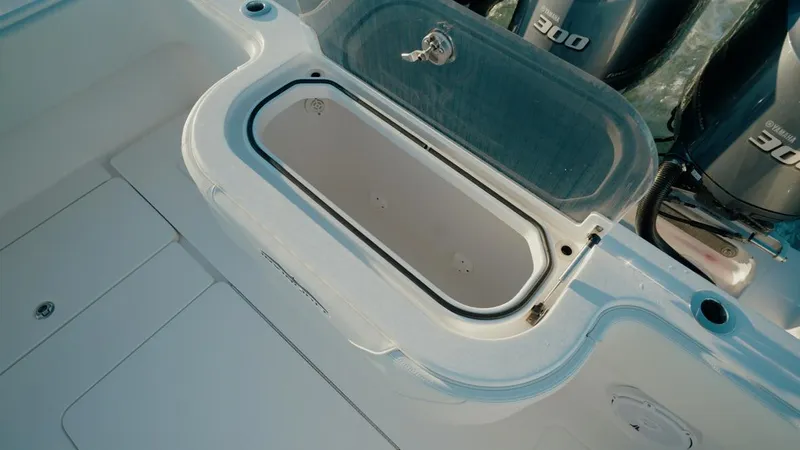 Slide: The Image of 2020 Invincible 36 CC boat with open storage compartment and powerful engines. - 5