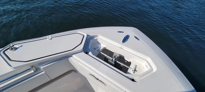 Slide: The Image of Bow of 2020 Invincible 36 CC boat with open storage compartment on water. - 8