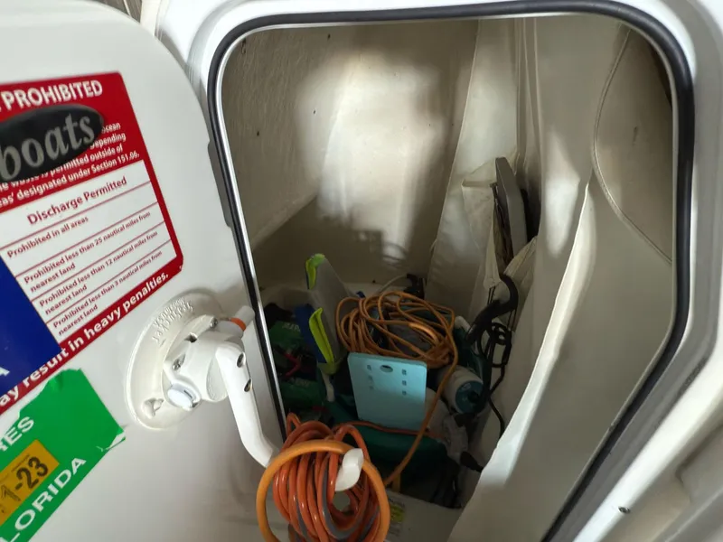 Slide: The Image of Storage compartment of 2020 Tidewater 2300 Carolina Bay boat with cables and equipment. - 11