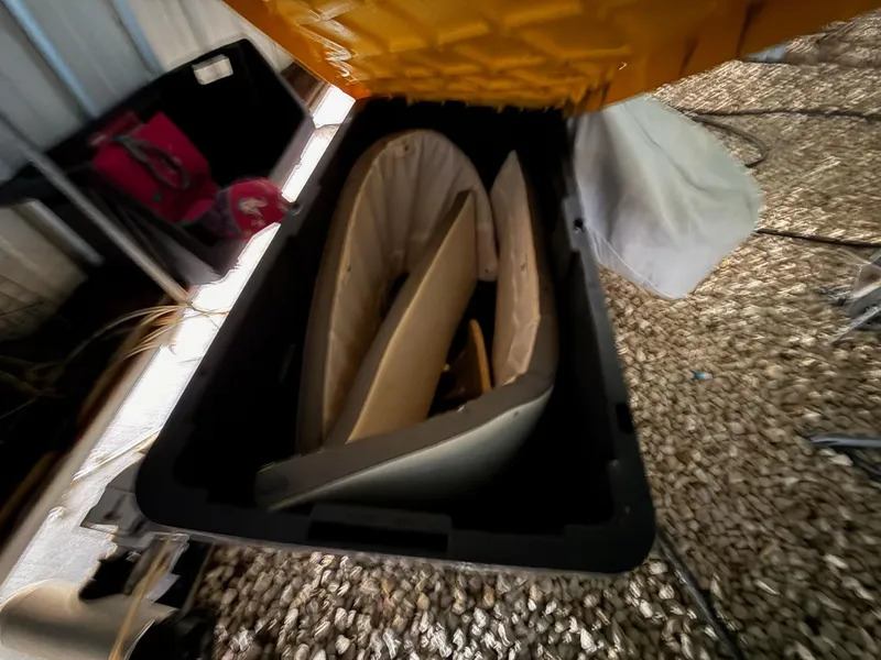 Slide: The Image of Storage compartment of a 2020 Tidewater 2300 Carolina Bay boat, containing various items. - 13