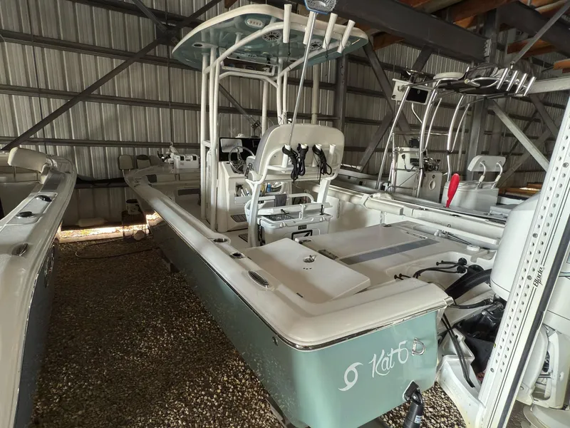 Slide: The Image of 2020 Tidewater 2300 Carolina Bay boat in storage, featuring a sleek design and center console. - 18