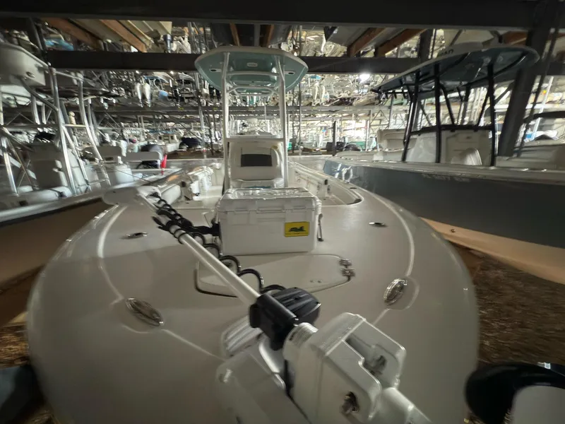 Slide: The Image of 2020 Tidewater 2300 Carolina Bay boat in storage, featuring a sleek design and modern equipment. - 22