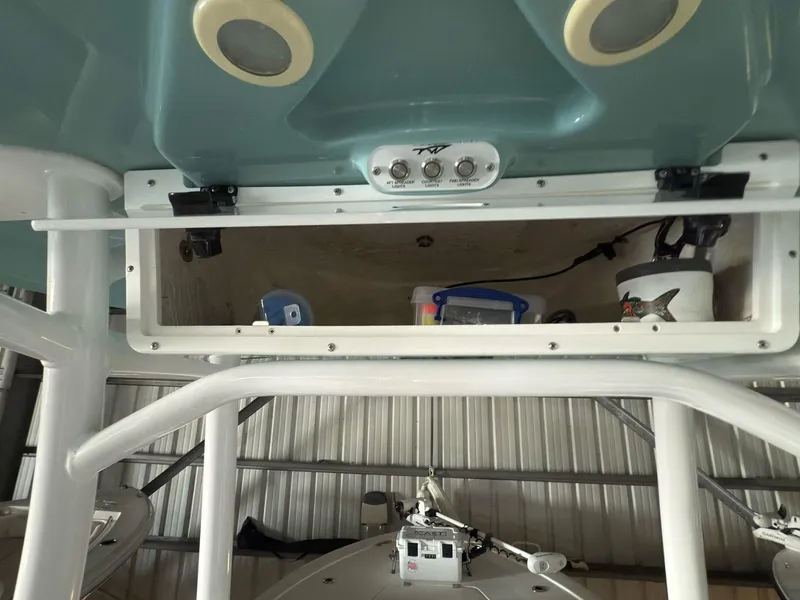 Slide: The Image of 2020 Tidewater 2300 Carolina Bay boat storage compartment with fishing gear. - 24