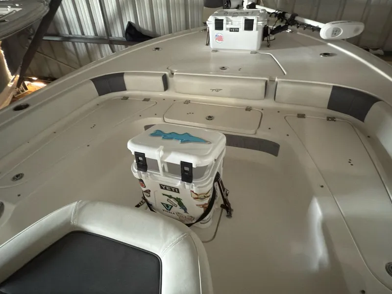 Slide: The Image of 2020 Tidewater 2300 Carolina Bay boat interior with cooler and fishing equipment. - 26