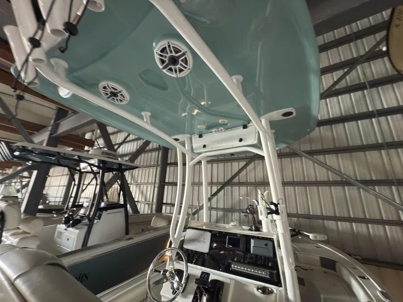Slide: The Image of 2020 Tidewater 2300 Carolina Bay boat interior with console and speakers in storage facility. - 27