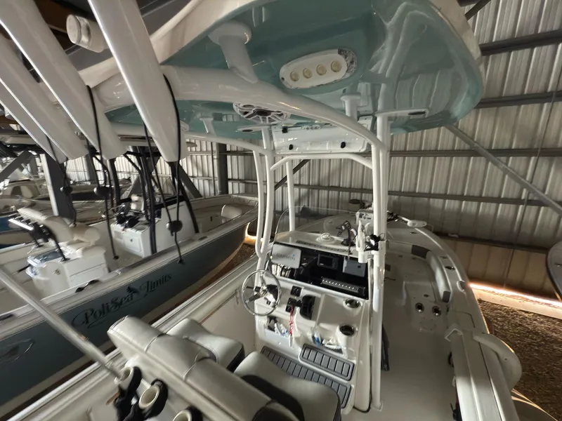 Slide: The Image of 2020 Tidewater 2300 Carolina Bay boat interior with console and seating in storage facility. - 9