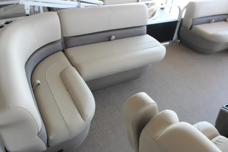 Slide: The Image of 2025 Sun Tracker Party Barge 16 DLX interior with beige seating and spacious layout. - 5